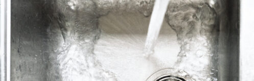 Water pouring into kitchen sink