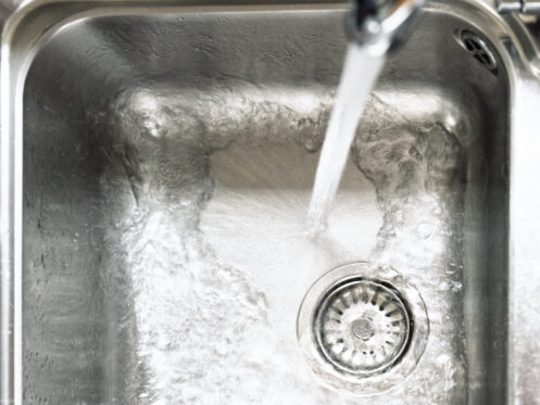 Water pouring into kitchen sink